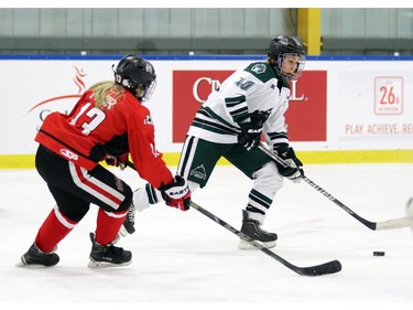 Wild Maddie Vockeroth-Fisher tries to get the puck past Capitals McKenzie Muir, 13, as the Northern Capitals played the Kootaney Wild on December 28, 2015 in the Mac's Midget Tournament rink 2.