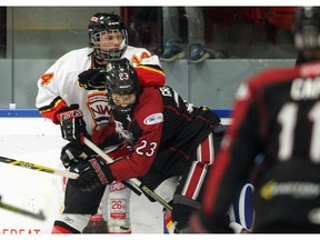 Calgary Flames forward Zach Russell, left, and Vancouver Northwest Giants forward Jack Graham battled along the boards during semi final action at the Mac's AAA Midget Tournament at Max Bell on December 31, 2015.