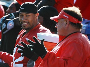 Calgary Stampeders linebacker Deron Mayo , left, talks with defensive co-ordinator Rich Stubler on the sidelines during an October practice. Stubler has defected from the squad in a shocking move, reportedly bound for the Toronto Argonauts.