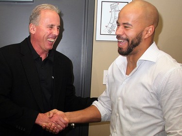 Calgary Stampeders coach John Hufnagel, left, shares a laugh with Jon Cornish after announcing that the running back has agreed to a contract extension Tuesday December 13, 2011.