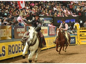 Saddle bronc racer Zeke Thurston parades around the arena at the National Finals Rodeo in Las Vegas.