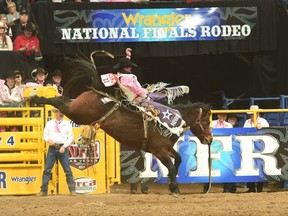 Kaycee Feild bucks out a 91-point ride on Calgary Stampede horse Reckless Margie — matching the second-highest score ever recorded in the National Finals Rodeo bareback competition — on Night 5 in Las Vegas.