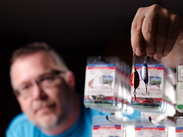 Norm Price shows off his handmade fishing lures at his home in Balzac on Wednesday, Dec. 16, 2015. Price has recycled bottle caps for many years into lures in an effort keep the caps from entering landfills.