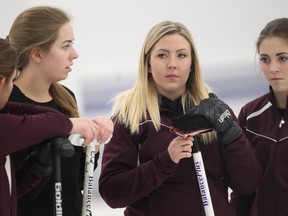 Skip Selena Sturmay of the Airdrie junior women's team chats with her teammates, from the left, vice Veronica Maschmeyer, second Sydney Parent and, right, lead Hope Sunley during the Ray Kingsmith Scholarship Bonspiel at the Calgary Winter Club Tuesday December 29, 2015. The team is among favourites at the provincials this weekend.