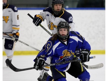 Andrea Sanderson of the Westman Wildcats gets shoved to the ice by Madeleine Ericsson of the Fraser Valley Rush their 2-2 tie at the Mac's Midget Tournament Wednesday December 30, 2015 at Max Bell Arena.