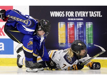 Andrea Sanderson, left, of the Westman Wildcats gets her stick caught under Madeleine Ericsson of the  Fraser Valley Rush after colliding against the boards during the Mac's Midget Tournament Wednesday December 30, 2015 at Max Bell Arena.