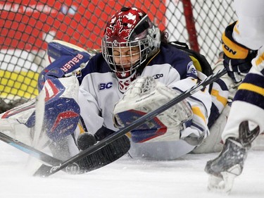 Netminder Cassie Shokar of the Fraser Valley Rush lunges for a loose puck during the third period of their 2-2 tie with the Westman Wildcats during the Mac's Midget Tournament Wednesday December 30, 2015 at Max Bell Arena.