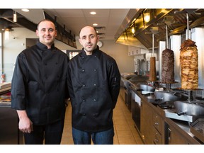 Alaa Abufarha, left, and his brother Izzo stand in their restaurant Jerusalem Shwarma