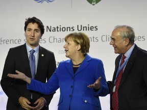 Prime Minister Justin Trudeau, German Chancellor Angela Merkel and OECD president Angel Gurria attend the Heads of State media event on carbon pricing, as part of the COP21 United Nations conference on climate change in Le Bourget on the outskirts of Paris on Nov. 30, 2015.
