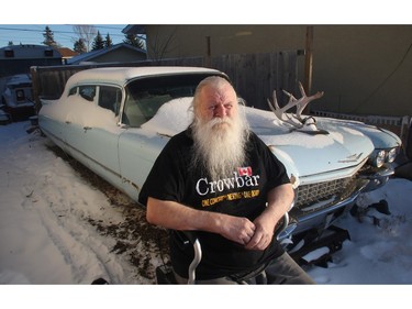 Kelly Jay, the former singer with iconic 70's Canadian rock band Crowbar, in his walker beside the Cadillac in his Penbrooke Meadows driveway  Wednesday November 25, 2015. The City is threatening to remove the Caddy and the band's tour bus from his backyard.