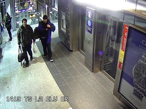 Calgary police released these surveillance camera images of two man being sought in connection with anti-Muslim graffiti spray-painted at the Tuscany CTrain station and its parking lot.