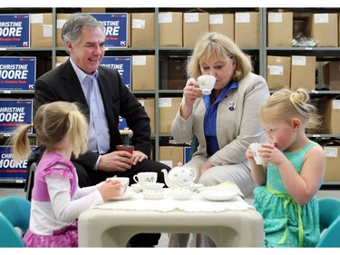 Alberta premier JimPrentice and his wife Karen hd a bit of tea with Sydney Buckland, 3, left, and Rachel Flett, 4. They were on the campaign trail stopping in Red Deer and door knocking in Calgary on May 4, 2015 the day before the election.