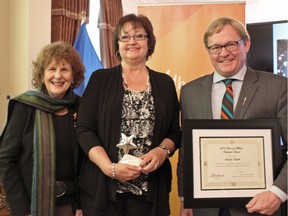 Roberta Rehill of Hanna (middle) is presented with a 2015 Stars of Alberta Volunteer Award in the Adult category by Lt.-Gov. Lois Mitchell and Alberta Culture and Tourism Minister David Eggen in Edmonton on Friday, December 4, 2015.