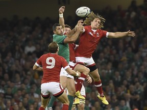 Canada's wing Jeff Hassler (R) jumps for the ball during a Pool D match of the 2015 Rugby World Cup between Ireland and Canada at the Millenium stadium in Cardiff, south Wales Sept. 19. A trip to watch rugby also provided a chance to tour Great Britain.