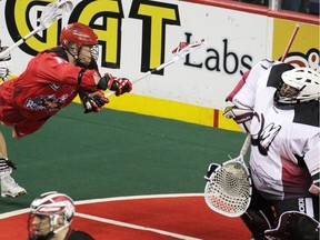 Calgary Roughnecks star Curtis Dickson, seen trying to score on Colorado Mammoth goaltender Alex Buque during National Lacrosse League action last April, will lead a scoring-by-committee attack this season.