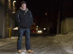 Neil Dunn stands in an alley in the Beltline area, after spending the afternoon with his 11-year-old daughter handing out gift cards to homeless people in Calgary, on December 21, 2015.