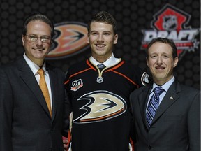 Shea Theodore, seen here with officials from the Anaheim Ducks sweater after being chosen 26th overall in the first round of the NHL hockey draft, Sunday, June 30, 2013, in Newark, N.J.