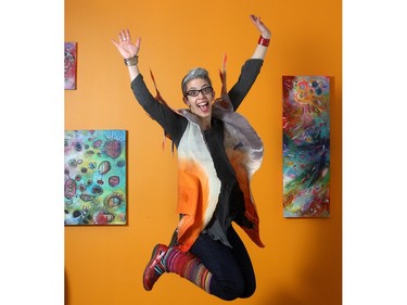 Artist Belinda Fireman shows her style in the basement studio of her SW Calgary home Thursday February 12, 2015. She is wearing a vest by local artist Viva Felt, a red leather cuff by Fehu, a shirt by Nally and Millie, Gap jeans, homemade knit leg warmers and Naot shoes. For Style in the City.