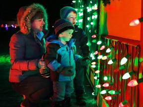Visitors check out the Christmas village, part of the large Christmas light display at Spruce Meadows on December 14, 2014.
