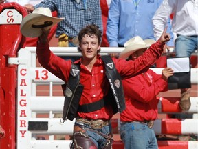 Zeke Thurston of Big Valley, Alta., celebrates after winning $100,000 on Easy To Love with a score of 88.50 in the Calgary Stampede finals on July 12. It was his second major victory of his rookie season.