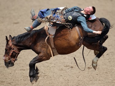 Orin Larsen of Inglis, Manitoba rides Mile Away during the Bareback competition at the Calgary Stampede Rodeo Wednesday July 9, 2015.