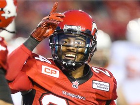 Calgary Stampeders defensive back Joe Burnett cheers at McMahon Stadium during a September game. The CFL team announced his re-signing on Tuesday.