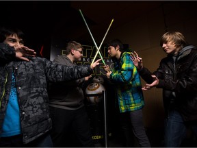 It's light side versus dark side as Leo Mustafa, left, Dominik Kyncl, Jeremy Andrei and Donald Morton pose prior to seeing the IMAX showing of Star Wars at Chinook Cineplex.