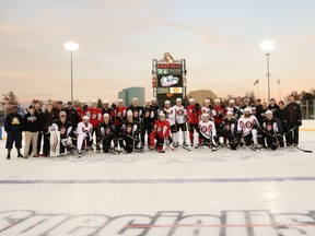 Members of the Stockton Heat pose on the outdoor rink at Raley Field on Thursday. They'll face the Bakersfield Condors on Friday night at Sacramento's baseball stadium.