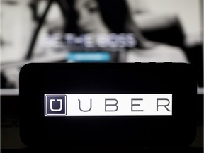 Local Input~ The Uber Technologies Inc. logo and website are displayed on an Apple Inc. iPhone 5s and laptop computer in this arranged photograph in Washington, D.C., U.S., on Wednesday, March 5, 2014. Uber, a startup that lets drivers pick up passengers with their personal cars and that was valued at $3.5 billion in a funding round last year, has raised $307 million from a group of backers that include Google Ventures, Google Inc.Õs investment arm, and Jeff Bezos, the founder of Amazon. Photographer: Andrew Harrer/Bloomberg    1218-biz-xFPuber ORG XMIT: POS1511251438480554
