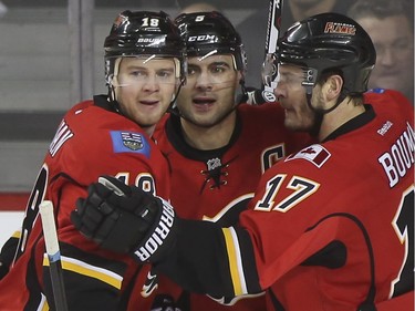 Calgary Flames Matt Stajan, Mark Giordano and Lance Bouma celebrate after Stajans goal during game action against the Tampa Bay Lightning at the Saddledome in Calgary, on January 5, 2016