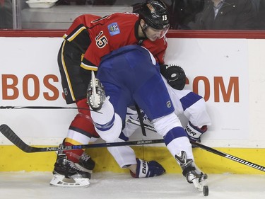 Calgary Flames Ladislav Smid gives Tampa Bay Lightning Cedric Paquette a shove during game action at the Saddledome in Calgary, on January 5, 2016.