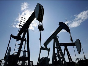 FILE PHOTO: Pumpjacks pump crude oil near Halkirk, Alta., June 20, 2007. A program in Alberta to deal with thousands of dormant oil and gas wells that don't meet safety and monitoring standards needs to be strengthened, critics say as falling crude prices could see their numbers swell.