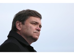 Alberta Agriculture Minister Oneil Carlier listens to hundreds of local farmers and ranchers protest Bill 6 in Okotoks on Dec. 1, 2015.