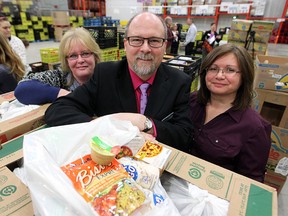 The Calgary Food Bank announced their latest project on Jan. 19, 2016, Weekends And More (WAM), providing school-aged children with easy to prepare food. WAM is a collaborated effort to meet the needs of students who are food insecure at school or on the weekends. From left, CBE Trustee Pamela King, Calgary Food Bank CEO James McAra and Esther Peltier, a teacher at Cecil Swanson School, were on hand for the unveiling.