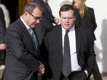 Ric McIver (L), the interim leader of the Alberta Tories, shakes hands with MP Jason Kenney after the funeral of Ronald D. Southern at Spruce Meadows in Calgary, Alta., on Thursday, Jan. 28, 2016. Ron Southern, a prominent philanthropist and businessman, is best known for start the Spruce Meadows show jumping facility 40 years ago and building ATCO into an international business powerhouse. Lyle Aspinall/Postmedia Network