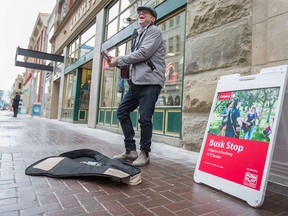 John Rutherford, street musician, busks on Stephen Avenue on Jan. 14. There will now be three types of busking IDs available.