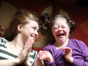 Emily Pitchers, 16, right, adores her older sister, Lorcan, and they enrich each others lives with their relationship. (Christina Ryan/Calgary Herald)