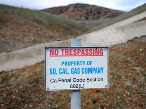 A sign declares the boundary line of the Southern California Gas Co. gas fields where a gas well has been leaking methane daily near the community Porter Ranch, Calif., Thursday, Jan. 7, 2016. California Gov. Jerry Brown declared a state of emergency over the massive natural-gas leak that has been spewing methane and other gases into a Los Angeles neighborhood for months, sickening residents and forcing thousands to evacuate.