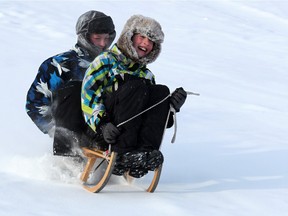 Gavin Young, Calgary Herald CALGARY, AB: JANUARY 04, 2014 -- Friends Rylan Kurrant, 11, and David Macleod, 12, get first tracks through the fresh snow on the toboggan hill in St. Andrew's Heights on a cold Saturday Jan. 4, 2013. Photo by Gavin Young/Calgary Herald  (For City section story by None) Trax# 00051823A