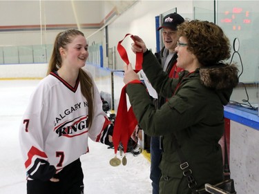 Crew captain Taryn Glimpel gets her gold medalThe Calgary NW Crew earned a gold medal with an overtime 4-to-3 win over the Saskatoon Ice in the U19A division of the Esso Golden Ring tournament on  Sunday, January 17, 2016.