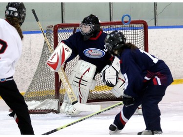 Ice goalie Jessica Wiebe loses track of the ring that Crew member  Alyssa Hall threw her way. The Calgary NW Crew earned a gold medal with an overtime 4-to-3 win over the Saskatoon Ice in the U19A division of the Esso Golden Ring tournament on  Sunday, January 17, 2016.