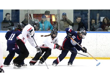 Ice Madison Ryan, 15, tries to keep the ring ahead of Crew Alyssa Hall  while Maija Kuan, 11, and Riley Kemp, 11 come up behind. The Calgary NW Crew earned a gold medal with an overtime 4-to-3 win over the Saskatoon Ice in the U19A division of the Esso Golden Ring tournament on  Sunday, January 17, 2016.