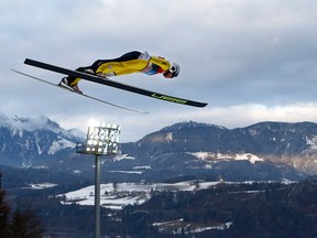 Canada's Mackenzie Boyd-Clowes soars through the air at the fourth stage of the 64. four hills ski jumping tournament in Bischofshofen, Austria, Wednesday, Jan. 6