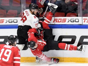 Canada's Brandon Hickey is upended by Switzerland's Timo Meier during a preliminary round game at the IIHF World Junior Championship in Helsinki, Finland. Hickey, a Calgary Flames prospect, acquitted himself well.