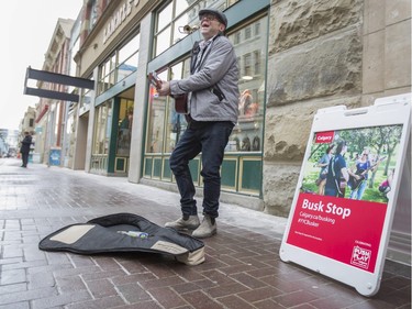 John Rutherford, street musician, busks on Stephen Ave at the City's announcement of the new "rockin' changes" they are implementing for street performers for 2016 in Calgary, on January 14, 2016. There will now be three types of busking ID's available, a standard busker ID, a Calgary Transit busker ID and the new Busk Stop busker ID.