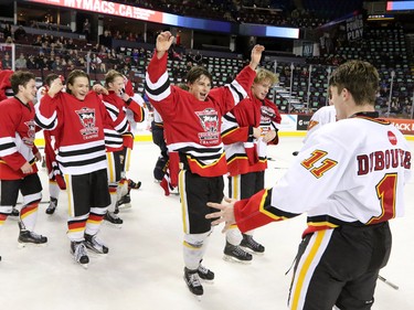 The Calgary Flames midget team celebrate winning the Mac's Midget Boy's Championship game at the Scotiabank Saddledome on New Year's Day.