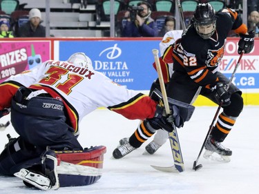 Calgary Flames goalie Adam Marcoux fends of this scoring chance by Lloydminster's Parker Saretsky during the Mac's Midget Championship game at the Scotiabank Saddledome on New Year's Day.