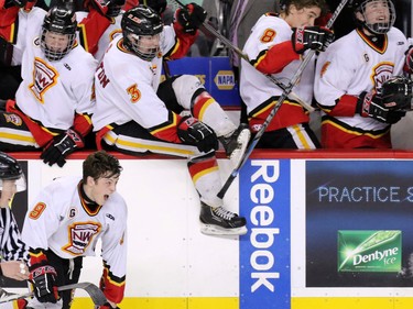 The Calgary Flames midget team leap on the ice after winning the Mac's Midget Boy's Championship game at the Scotiabank Saddledome on New Year's Day.