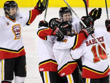 The Calgary Flames midget team celebrate Lindon Babcock's winning goal to take the Mac's Midget Championship game at the Scotiabank Saddledome on New Year's Day.