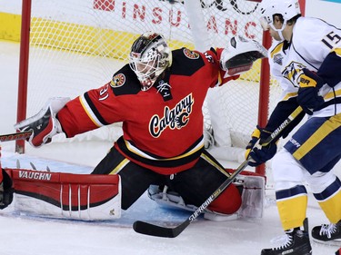 Calgary Flames goaltender Karri Ramo stops this scoring chance as the Nashville Predators'  Craig Smith looks for a rebound during the first period of NHL action at the Scotiabank Saddledome on Wednesday January 27, 2016.